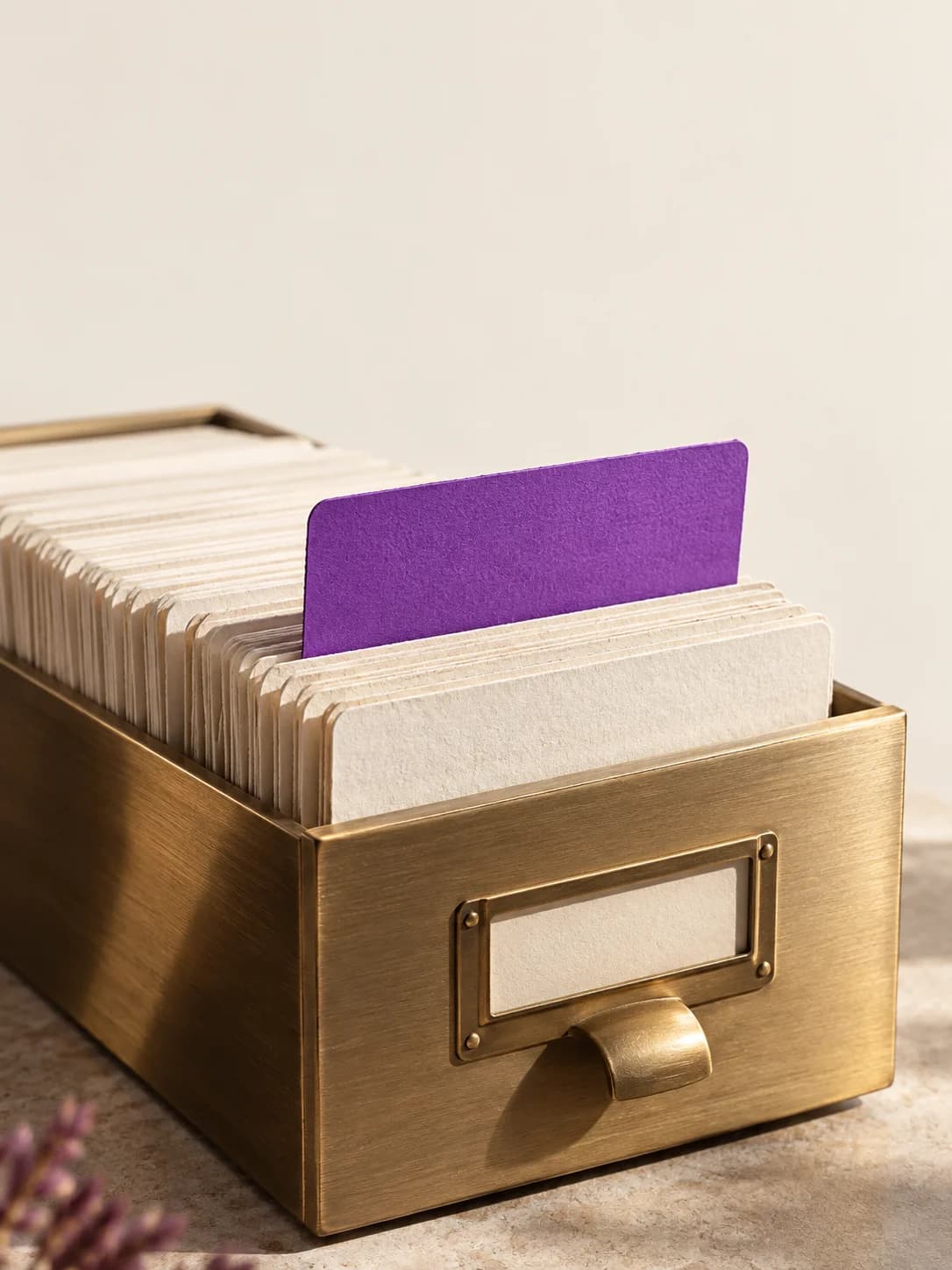 A violet index card standing out from an archive, an editorial illustration